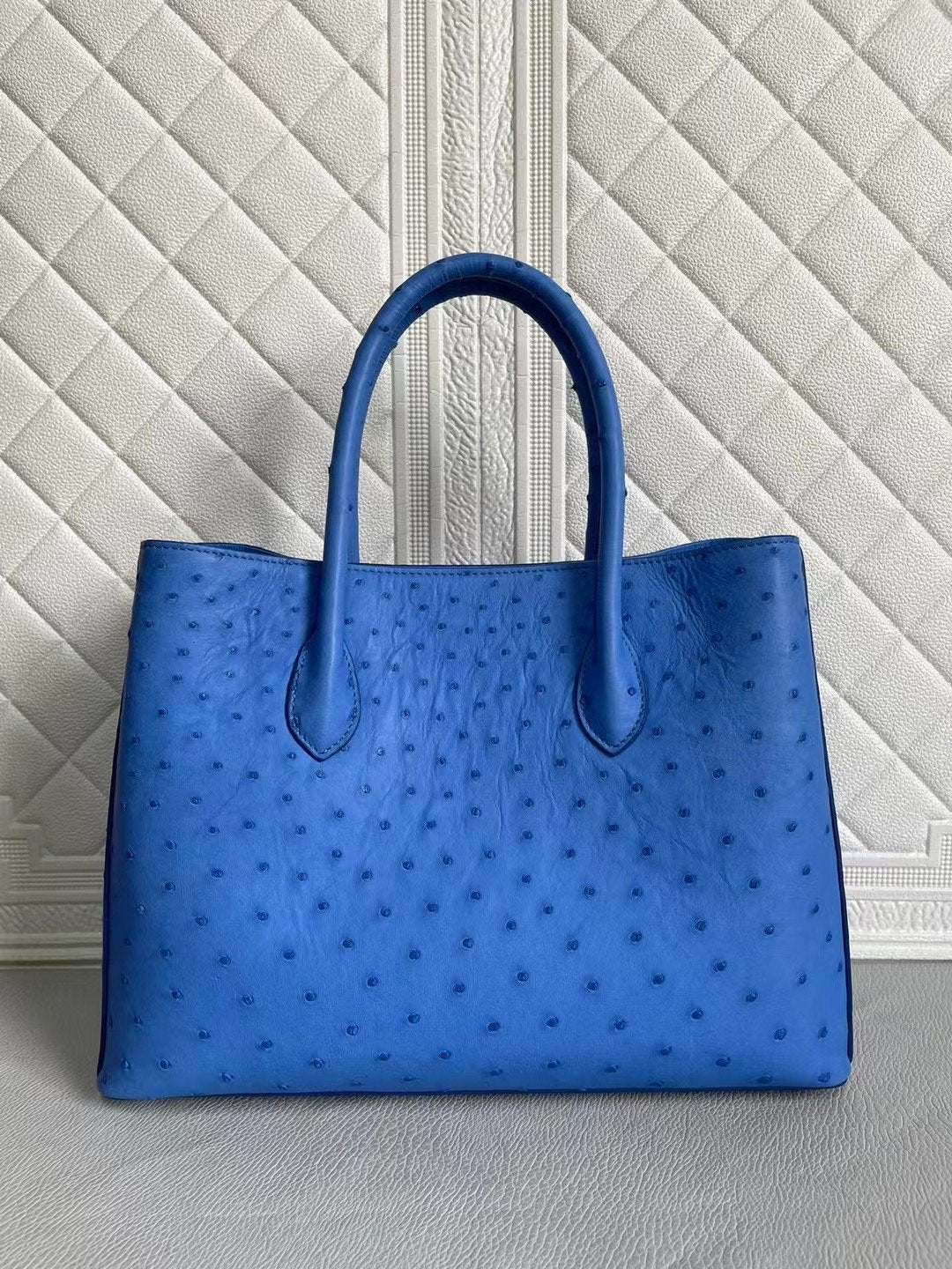 Blue and cream women's ostrich leather handbag with top handle and cross-body strap, 33cm size, by Rossie Viren.